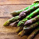 A bundle of fresh spring asparagus with vibrant green stalks and tight tips ready for an elegant recipe.