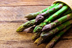 A bundle of fresh spring asparagus with vibrant green stalks and tight tips ready for an elegant recipe.